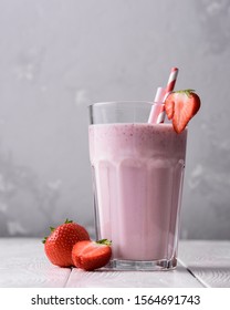 Strawberry Protein Shake On A White Wooden Background. Fresh Milkshake With Strawberries On A Light Table. A Glass Of Strawberry Smoothie.