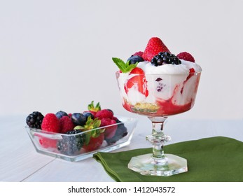 Strawberry, Raspberry, Blackberry Trifle Topped With Whipped Cream In Glass Bowl