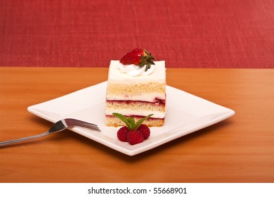 Strawberry or raspberry cake with a fork