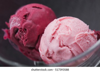 Strawberry And Raspberry Ice Cream In Glass Bowl On Dark Background