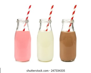 Strawberry regular and chocolate milk in bottles with striped straws isolated on white                  
