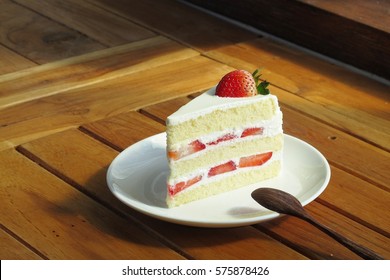 Strawberry short cake on wooden table 