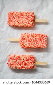 Strawberry shortcake ice cream bars with cake crumbles