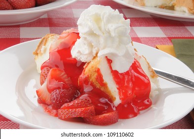 Strawberry shortcake on angle food cake served on a picnic table