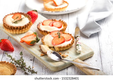 Strawberry shortcake pies on rustic wooden table, perfect party individual fresh fruit dessert
