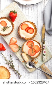Strawberry shortcake pies on rustic wooden table, perfect party individual fresh fruit dessert
