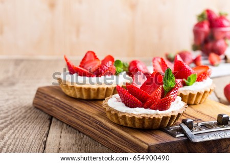 Strawberry shortcake pies on rustic wooden table,  perfect party individual fresh fruit dessert 