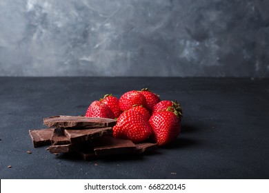 Strawberry with slices of chocolate on a dark background - Powered by Shutterstock