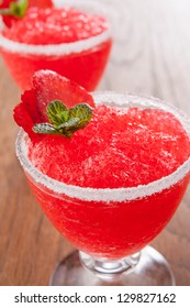 Strawberry Slushie Cups Decorated With Mint On Wooden Table