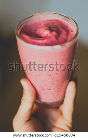 Similar – Mann hält einen Milchshake aus Beeren und Haferflocken.