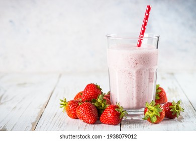 Strawberry smoothie or milkshake at white.