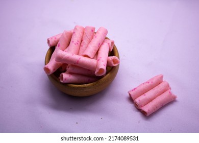 Strawberry sweet Wafer Cream Rolls isolated on violet background - Shutterstock ID 2174089531