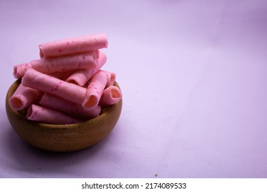 Strawberry sweet Wafer Cream Rolls isolated on violet background - Shutterstock ID 2174089533