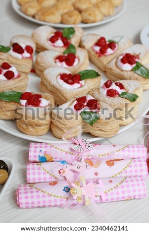 Strawberry Tart with Fresh Cream in Puff Pastry on wooden mat. heart shaped fruit on tart. 