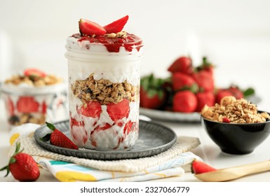 Strawberry Yoghurt Parfait on Drinking Jar.  Greek Yoghurt with  Granola and Strawberry Jam. 
