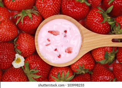 Strawberry Yogurt On A Spoon Over Fresh Strawberries