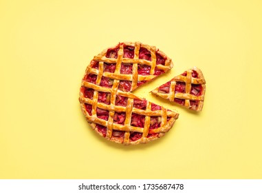 Strawberry-rhubarb pie sliced for one, with a lattice crust, on a yellow seamless background. Flat lay with rhubarb pie. Sweet vegetable tart. - Powered by Shutterstock