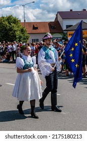 Straznice, Czech Republic - June 25, 2022 International Folklore Festival.Boy and girl with the EU flag in folk costumes