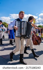 Straznice, Czech Republic - June 25, 2022 International Folklore Festival. A man in folk costume plays the accordion in the procession