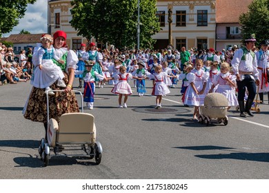 Straznice, Czech Republic - June 25, 2022 International Folklore Festival. Children and women with strollers in traditional costumes