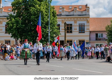 Straznice, Czech Republic - June 25, 2022 International Folklore Festival. Front of the procession with flags in folk costumes