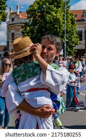 Straznice, Czech Republic - June 25, 2022 International Folklore Festival. A man with a child in his arms, in a folk costume