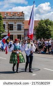 Straznice, Czech Republic - June 25, 2022 International Folklore Festival. A boy and a girl carry the Czech flag in a procession