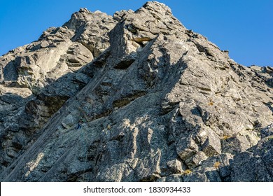 Strbske Pleso, Slovakia - September 14, 2020: Mountain Climbing - A Climber On A Belaying Post After Leading The First Pitch.