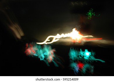 Streaking Lights With Interior Dash Of Truck Against A Black Background From Moving Cars And Slow Camera Shutter Speed 