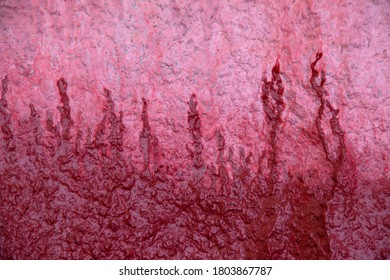 Streaks Of Red Paint On The Pink Surface.