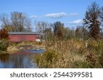 Stream, floodplain, covered bridge and wetland restoration along a stream. It stabilizes and alters the stream channel to slow and direct the flow of water to reduce erosion and flooding.