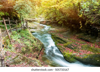 Stream Flowing Through Rocks in forest.