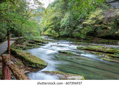 Stream Flowing Through Rocks in forest.