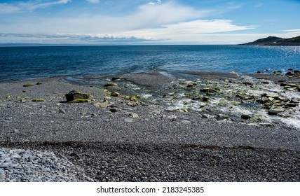 Stream Flows Into Sea On Stone Beach