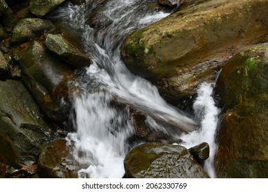 The stream flows over a swift river