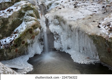 The Stream Is Freezing. Stones Are Covered With Ice, Overgrown With Icicle - Winter.