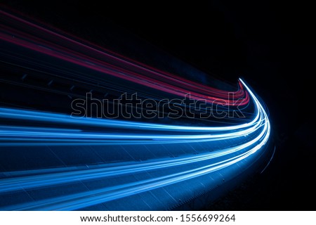 Stream of light trails on motorway at night