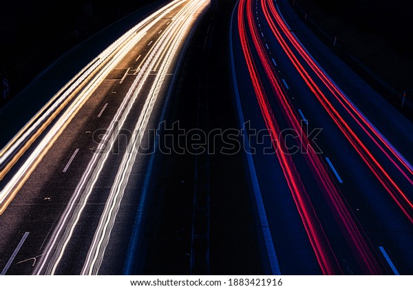 Stream of light\
trails on motorway at\
night