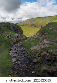 Stream running over High Cup Nick at the head of the dramatic High Cup Gill chasm, Eden Valley, North Pennines, Cumbria, UK - Shutterstock ID 2220620385