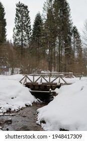 A stream in the snow  capped mountains   wooden bridge  Mountain river  Carpathians  Ukraine  Selective focus 