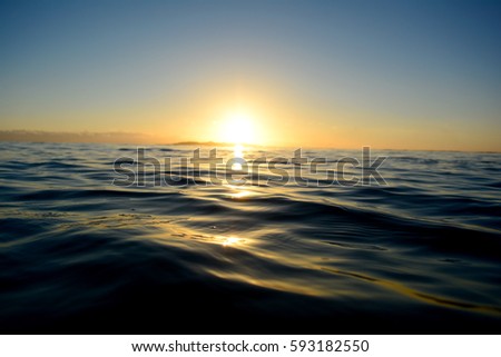 
A stream of sunlight rising over the ocean