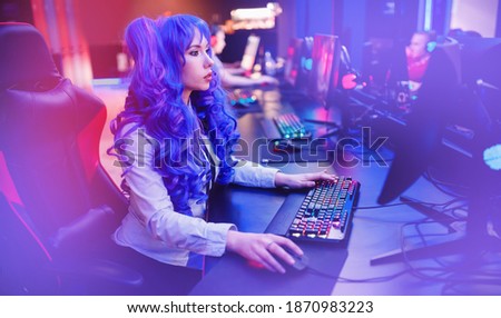 Streamer anime cosplay woman professional gamer playing online video games computer, neon color.