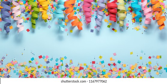 Streamers And Confetti On Blue Background.Birthday Decoration.