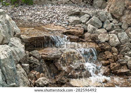Streamlet among the stones with a small waterfall Stock fotó © 
