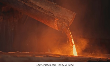 Streams of hot metal fill molds at factory. Stock footage. Beautiful molten metal pours into molds. Streams of metal flow at metallurgical plant - Powered by Shutterstock