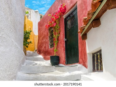 Street in Anafiotika, Plaka district, Athens, Greece. Plaka is famous tourist attraction of Athens. Cozy alley, vintage houses at Acropolis slope in old Athens town. Theme of places, travel in Athens - Powered by Shutterstock