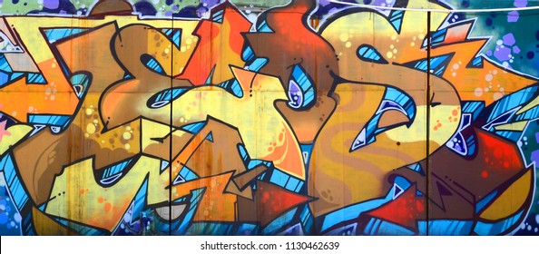 Street art. Abstract background image of a full completed graffiti painting in beige and orange tones