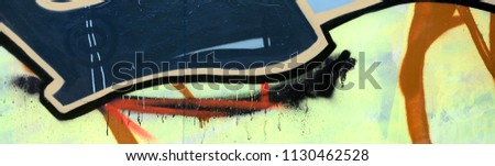 Street art. Abstract background image of a fragment of a colored graffiti painting in dark grey and red tones