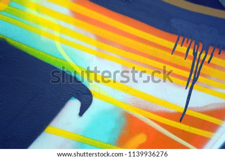 Street art. Abstract background image of a fragment of a colored graffiti painting in khaki green and orange tones