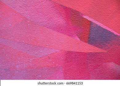 Street art. Colorful graffiti on the wall. Detail of a graffiti. Red abstract background painting